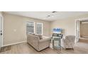 Living room with light colored couch and wood-look flooring at 1493 Janet Pl, Englewood, FL 34223