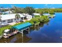 Waterfront home with a private dock and boat lift on a calm waterway at 1493 Janet Pl, Englewood, FL 34223