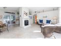 Living room features a fireplace, comfortable seating and adjacent dining area at 1770 Hudson St, Englewood, FL 34223