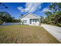 Newly built home with light blue siding, white trim, and a grassy yard at 18302 Gypsy Ave, Port Charlotte, FL 33954