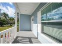 Quaint front porch with white railings and gray siding at 18302 Gypsy Ave, Port Charlotte, FL 33954