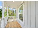 Wooden porch with white railings and window at 18399 Fremont Ave, Port Charlotte, FL 33954