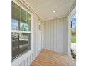 Wooden porch with white door and window at 18399 Fremont Ave, Port Charlotte, FL 33954