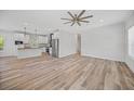 Open living room and kitchen with wood-look floors at 19095 Willard Ave, Port Charlotte, FL 33954