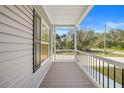 Covered front porch with wood-like deck flooring at 19095 Willard Ave, Port Charlotte, FL 33954