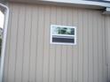 Side view of house showing tan vinyl siding and a window at 22507 Provance Ave, Port Charlotte, FL 33954