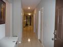 Clean hallway with tile floors and doors to other rooms at 22507 Provance Ave, Port Charlotte, FL 33954