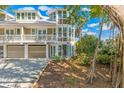 Stunning exterior view highlighting the two-story house and lush greenery at 45 Seawatch Lake Dr, Boca Grande, FL 33921