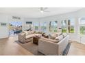 Bright living room boasts lots of natural light, neutral tones, hardwood flooring, and stylish furnishings at 45 Seawatch Lake Dr, Boca Grande, FL 33921