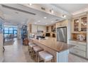 Spacious kitchen with an island breakfast bar, stainless steel appliances, and adjacent living area at 5000 Gasparilla Rd # 73A, Boca Grande, FL 33921