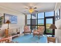 Relaxing sitting area features wicker furniture, ocean views, and ample natural light at 5000 Gasparilla Rd # 73A, Boca Grande, FL 33921