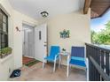 Small front porch with seating and access to condo at 502 Pine Hollow Cir # 502, Englewood, FL 34223