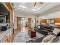 Spacious living room featuring a stone accent wall, hardwood floors, coffered ceilings, and barn doors to the office at 710 Albee W Rd, Nokomis, FL 34275