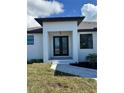Front entry with double doors and a covered porch at 7330 Printer St, Port Charlotte, FL 33981
