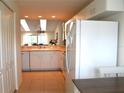 White kitchen with appliances and light countertops at 8100 Memory Ln # 207, Rotonda West, FL 33947