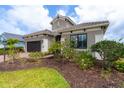 Two-story home with gray exterior and lush landscaping at 10958 Trevino St, Englewood, FL 34223