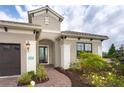 Front entry with brick walkway leading to covered entryway at 10958 Trevino St, Englewood, FL 34223