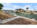 Waterfront backyard with a dock and boat lift, perfect for boating and enjoying the canal lifestyle at 1954 Arkansas Ave, Englewood, FL 34224