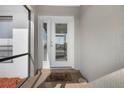 Inviting front entryway with brick landing, decorative mat and glass-paned door with sidelight window at 1954 Arkansas Ave, Englewood, FL 34224