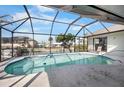 Inviting screened-in pool with beautiful waterfront views and ample seating for relaxing and enjoying the Florida sunshine at 1954 Arkansas Ave, Englewood, FL 34224