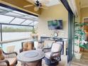 Outdoor patio area with a fireplace, seating area, and outdoor kitchen, perfect for entertaining by the pool at 170 Antilla Dr, Rotonda West, FL 33947