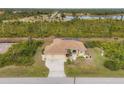 Expansive aerial view of the home showcasing its screened-in pool, landscaping, and neighborhood at 116 Hercules Dr, Rotonda West, FL 33947