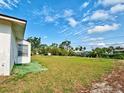 Large back yard featuring a partial view of the side of the home at 914 E 2Nd St, Englewood, FL 34223