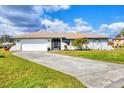 Charming single-story home with a well-manicured lawn and an attached two-car garage at 3522 Fox Ter, Port Charlotte, FL 33981