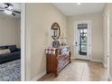 Inviting entryway with a wooden dresser, round mirror and decorative accents at 108 Wagon Place, Rotonda West, FL 33947