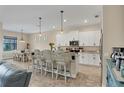 Open concept kitchen with breakfast bar, stainless steel appliances, and dining area at 108 Wagon Place, Rotonda West, FL 33947