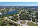 Expansive aerial view showcasing a beautiful home with a scenic lake in a peaceful neighborhood at 117 Cable Dr, Rotonda West, FL 33947