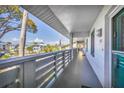 Long balcony showcasing views with a light rail, bright exterior, and access to units at 6800 Placida Rd # 235, Englewood, FL 34224