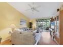 Bright living room with vaulted ceilings, a ceiling fan, hardwood floors, and a sliding glass door at 6800 Placida Rd # 235, Englewood, FL 34224
