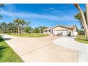 Spacious home with a large driveway, two-car garage, and well-manicured lawn at 891 Harmony Ln, Englewood, FL 34223