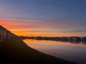 Sunset over the community lake offers a picturesque view from your condo at 3310 Loveland Blvd # 802, Punta Gorda, FL 33980