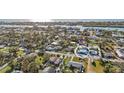 Aerial view showcases this charming blue home within a vibrant neighborhood near a tranquil river at 539 Shore Rd, Nokomis, FL 34275