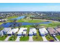 Aerial view of a picturesque community with golf courses and waterfront homes at 109 Westwind Dr, Placida, FL 33946