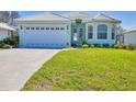 Lovely single-story home with a well-manicured lawn and an attached garage at 109 Westwind Dr, Placida, FL 33946