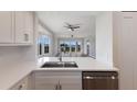 Bright, modern kitchen featuring white cabinets, stainless steel appliances, quartz countertops and beautiful water views at 11000 Placida Rd # 301, Placida, FL 33946