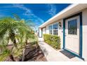 Inviting front entrance with well-maintained landscaping leading to the front door with sidelight windows at 13532 Romford Ave, Port Charlotte, FL 33981