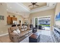 Open-concept living room with sliding glass doors to pool, seamlessly blending indoor and outdoor living spaces at 252 Australian Dr, Rotonda West, FL 33947