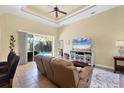 Bright living room featuring a ceiling fan, and sliding glass doors that open to the pool, creating an airy atmosphere at 252 Australian Dr, Rotonda West, FL 33947