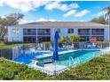 Community pool with plenty of seating and shade umbrellas at 5725 Greenwood Ave # 8101, North Port, FL 34287