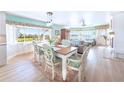 Bright dining room with views and an open concept to the living area and beautiful floral decorations and natural light at 11000 Placida Rd # 101, Placida, FL 33946