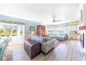 Inviting living room with calming paint, wood floors, water views, and an open concept to the dining area at 11000 Placida Rd # 101, Placida, FL 33946