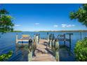 Dock with benches that offer a tranquil escape on the water, perfect for fishing or simply enjoying nature at 2375 N Beach Rd # 2B, Englewood, FL 34223