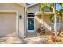 Close-up of the front door, showing beautiful decorative details and well-manicured landscaping, adding to the home's appeal at 100 Hobo Rd, Rotonda West, FL 33947