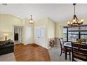 Inviting dining area with hardwood floors, chandelier, and a bay window allowing for plenty of natural light at 1087 Bay Harbor Dr, Englewood, FL 34224