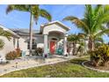 Charming home featuring a welcoming front entrance and beautifully landscaped yard at 13354 Blytheville Ave, Port Charlotte, FL 33981