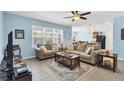 Bright living room featuring tile floors, neutral furniture and an open floor plan at 15081 Aldama Cir, Port Charlotte, FL 33981